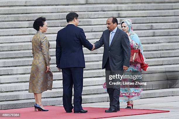 Lady Peng Liyuan, Chinese President Xi Jinping shankes hands with Mauritania's President Mohamed Ould Abdel Aziz and Tekber Mint Melainine Ould Ahmed...