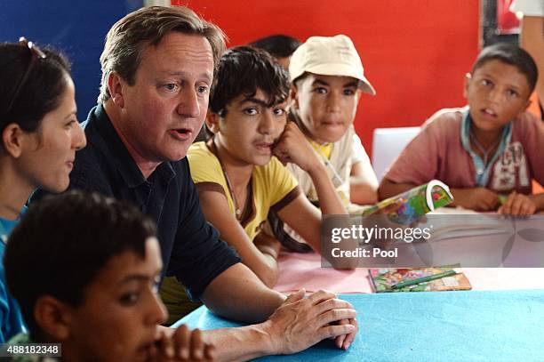 British Prime Minister David Cameron meets refugee children and teenagers at the UNICEF Makani Centre at the Za'atri refugee camp where he saw how...