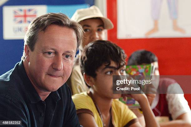 British Prime Minister David Cameron meets refugee children and teenagers at the UNICEF Makani Centre at the Za'atri refugee camp where he saw how...