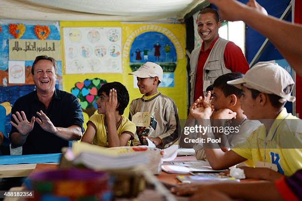 British Prime Minister David Cameron meets refugee children and teenagers at the UNICEF Makani Centre at the Za'atri refugee camp where he saw how...