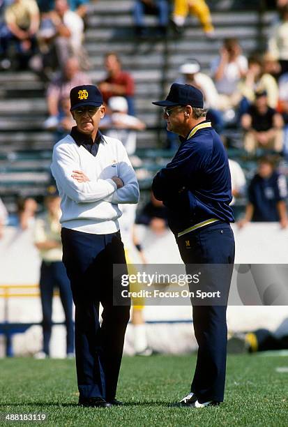 Head Coach Lou Holtz of the Notre Dame Fighting Irish talks with head Coach Bo Schembechler of the Michigan Wolverines prior to theirs NCAA Football...