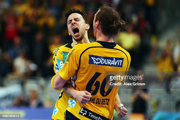 Patrick Groetzki of Rhein-Neckar Loewen celebrates a goal with team mate Kim Ekdahl du Rietz during the DKB Handball Bundesliga match between...