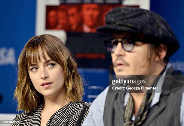 Actors Dakota Johnson and Johnny Depp speak onstage during the "Black Mass" press conference at the 2015 Toronto International Film Festival at TIFF...