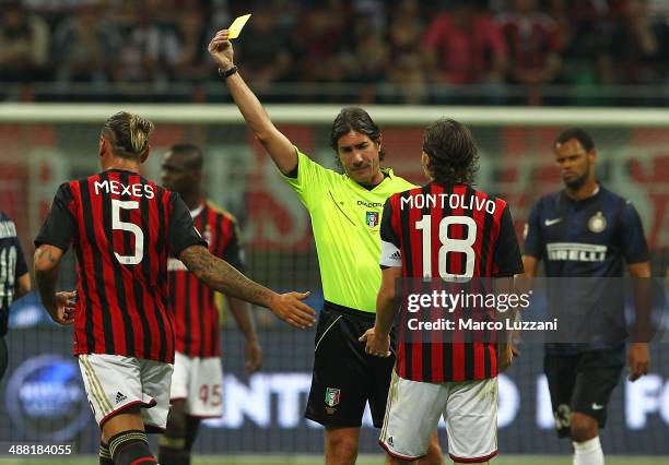 Referee Mauro Bergonzi shows the yellow card to Philippe Mexes of AC Milan during the Serie A match between AC Milan and FC Internazionale Milano at...