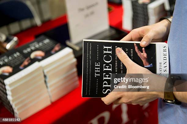 Senator Bernie Sanders, an independent from Vermont and 2016 Democratic presidential candidate, book is bought by a supporter before Sanders speaks...