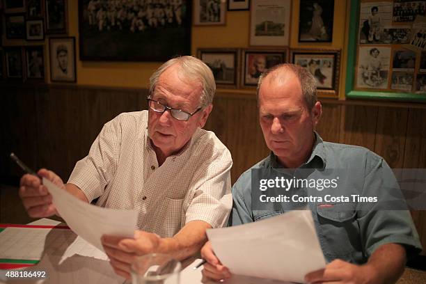 Ray Jaffke, left, a member since 1967, and his son, Todd Jaffke, discuss picks during Oakland Professional Pigskin Prognosticators League's annual...