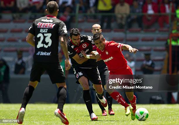 Carlos Rodriguez of Toluca fights for the ball with Christian Perellano of Tijuana during the Quarterfinal second leg match between Toluca and Xolos...