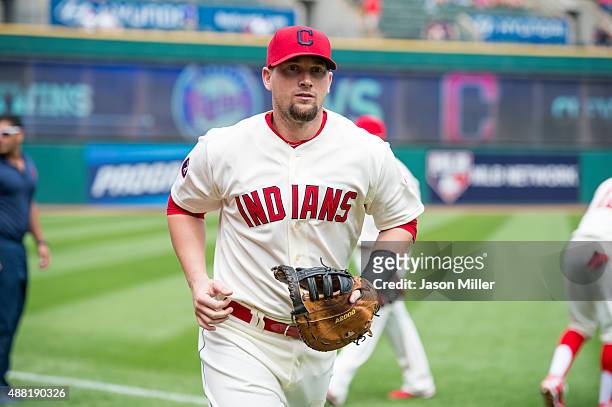 First baseman Chris Johnson of the Cleveland Indians leaves the field between innings against the Minnesota Twins at Progressive Field on August 9,...