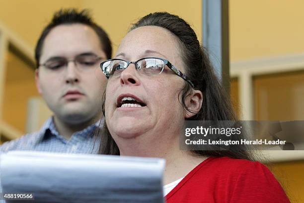 Rowan County Clerk Kim Davis, with son Nathan Davis, a deputy clerk, reads a statement to the press outside the Rowan County Courthouse on Sept. 14,...