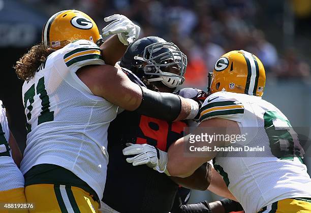 Will Sutton of the Chicago Bears is blocked by Josh Sitton and Corey Linsley of the Green Bay Packers at Soldier Field on September 13, 2015 in...