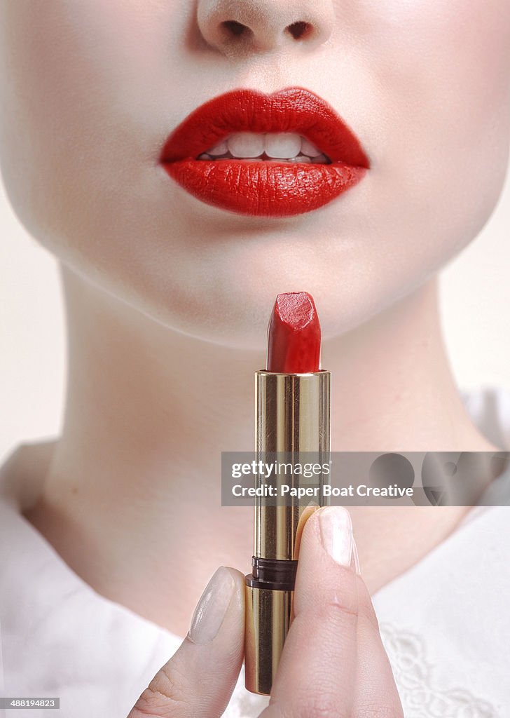 Close up of woman with lipstick and red lips