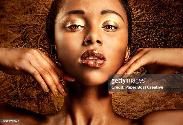 portrait of a woman with bronze and gold makeup - expensive statue stock-fotos und bilder