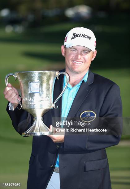 Holmes poses with the trophy after securing victory in the final round of the Wells Fargo Championship at the Quail Hollow Club on May 4, 2014 in...