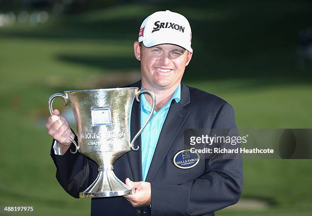Holmes poses with the trophy after securing victory in the final round of the Wells Fargo Championship at the Quail Hollow Club on May 4, 2014 in...