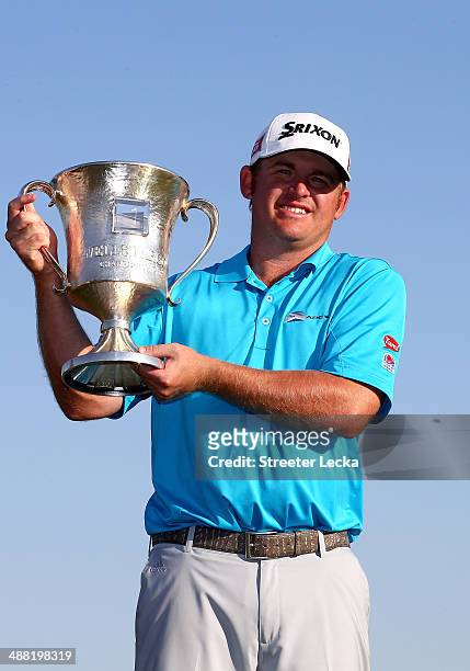 Holmes celebrates with the trophy after winning the Wells Fargo Championship in the final round on May 4, 2014 in Charlotte, North Carolina.