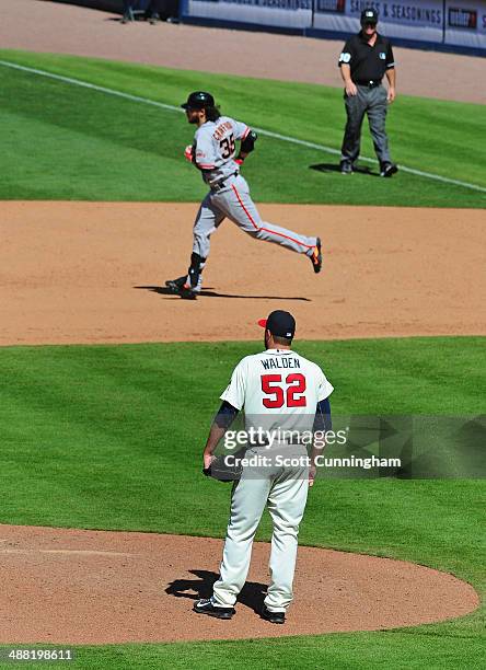 Brandon Crawford of the San Francisco Giants rounds the bases after hitting a two-run home run in the eighth inning against pitcher Jordan Walden of...
