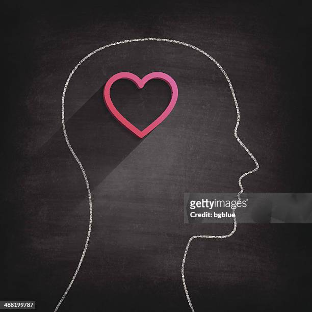 thinking about love on blackboard - chalkboard - one young man only stock illustrations