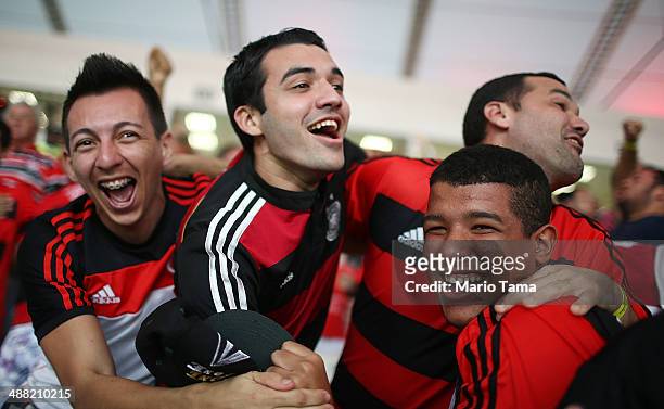 Flamengo supporters cheer during a match between Flamengo and Palmeiras as part of Brasileirao Series A 2014 at Maracana Stadium on May 04, 2014 in...
