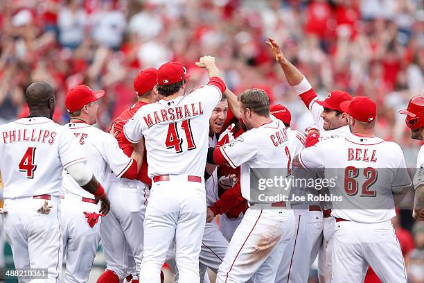 Todd Frazier of the Cincinnati Reds celebrates his winning hit with teammates after the game against the Milwaukee Brewers at Great American Ball...