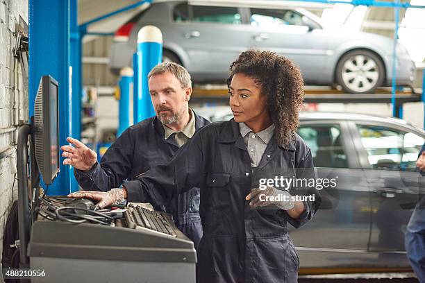 female auto mechanic with her boss - teacher board stock pictures, royalty-free photos & images