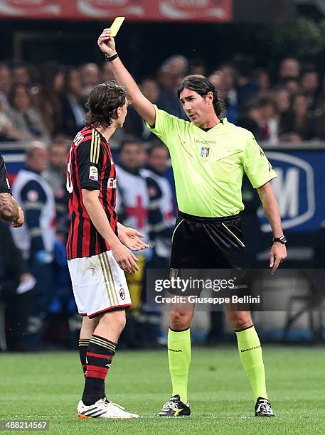 Referee Mauro Bergonzi shows the yellow card to Riccardo Montolivo of AC Milan during the Serie A match between AC Milan and FC Internazionale Milano...