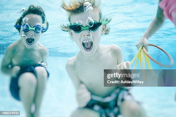 children screaming underwater playfully - baby girls stock pictures, royalty-free photos & images