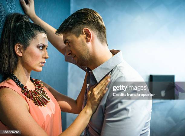 couple flirting in the restroom of a club - nightclub bathroom stockfoto's en -beelden