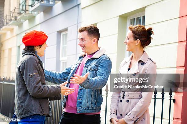 two friends meet on the street in front of girlfriend - introducing girlfriend stock pictures, royalty-free photos & images