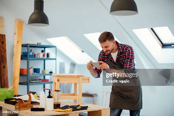 carpenter photographing furniture with his phone. - product photography stock pictures, royalty-free photos & images