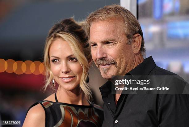 Actor Kevin Costner and wife Christine Baumgartner arrive at the Los Angeles premiere of 'Draft Day' at Regency Village Theatre on April 7, 2014 in...