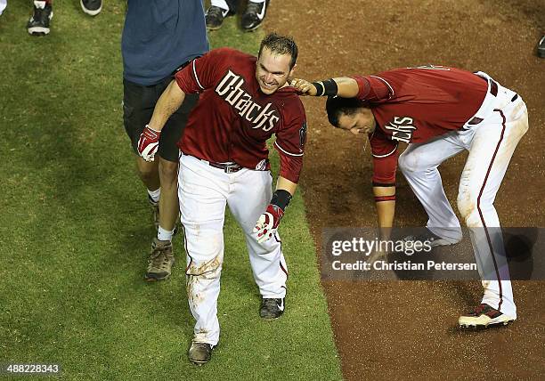 Miguel Montero of the Arizona Diamondbacks has dirt poured on him in celebration by Martin Prado after hitting a walk off solo home run against the...