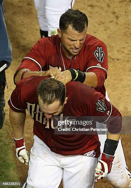 Miguel Montero of the Arizona Diamondbacks has dirt poured on him in celebration by Martin Prado after hitting a walk off solo home run against the...