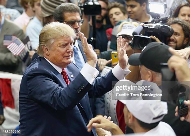 Republican presidential candidate Donald Trump greets supporters during a campaign rally at the American Airlines Center on September 14, 2015 in...