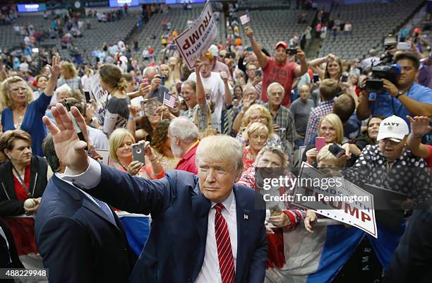 Republican presidential candidate Donald Trump greets supporters during a campaign rally at the American Airlines Center on September 14, 2015 in...