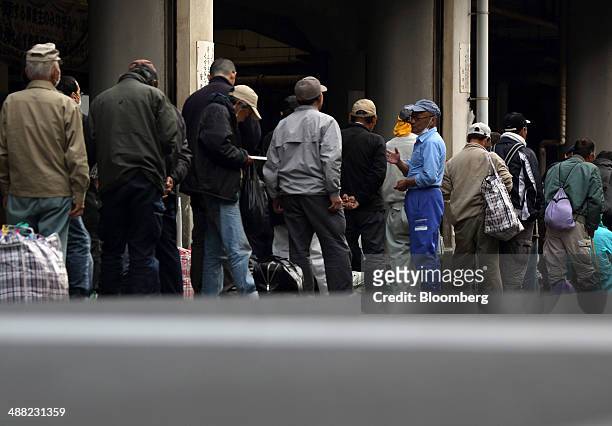 Day laborers wait in line to enter a shelter for homeless people in the Airin area of Nishinari ward in Osaka, Japan, on Friday, May 2, 2014. Osaka...