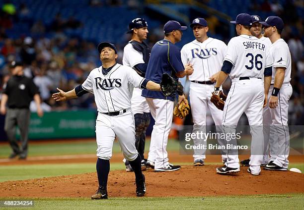 Pitcher Erasmo Ramirez of the Tampa Bay Rays reacts as he walks back to he dugout after giving up a no-hitter in the eighth inning and being taken...