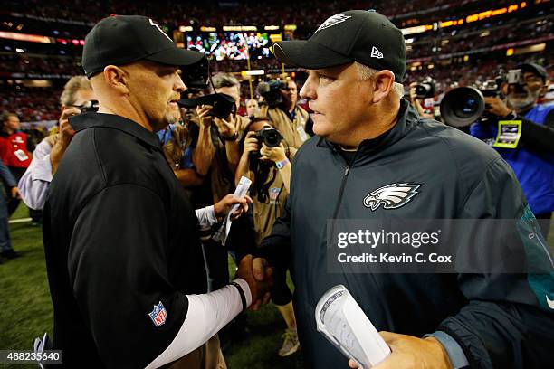 Head coach Dan Quinn of the Atlanta Falcons shakes hands with head coach Chip Kelly of the Philadelphia Eagles after the game at the Georgia Dome on...