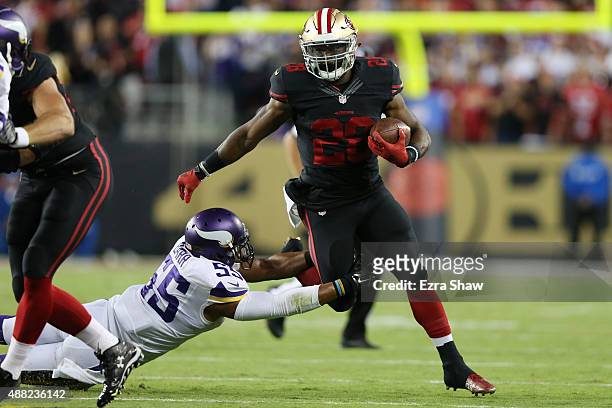 Carlos Hyde of the San Francisco 49ers rushes past Anthony Barr of the Minnesota Vikings during their NFL game at Levi's Stadium on September 14,...