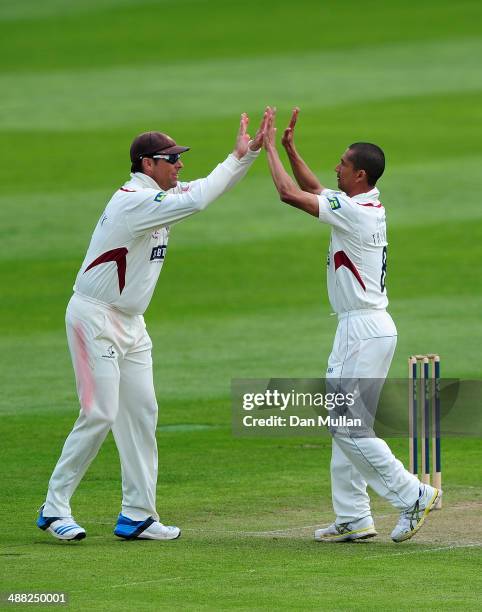 Alfonso Thomas of Somerset celebrates with Marcus Trescothick of Somerset after taking the wicket of Chris Read of Nottinghamshire during day two of...