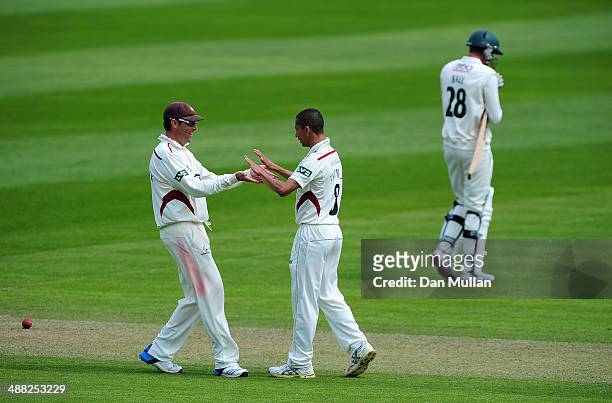 Alfonso Thomas of Somerset celebrates with Marcus Trescothick of Somerset after taking the wicket of Jake Ball of Nottinghamshire during day two of...