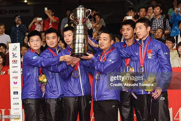 Zhendong Fan, Hao Wang, Long Ma, Coach Guoliang Liu, Jike Zhang and Xin Xu of team China pose with gold medal on the podium during day eight of the...