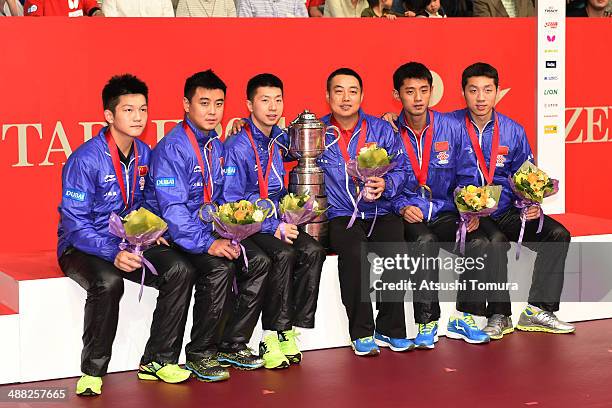 Zhendong Fan, Hao Wang, Long Ma, Coach Guoliang Liu, Jike Zhang and Xin Xu of team China pose with gold medal on the podium during day eight of the...