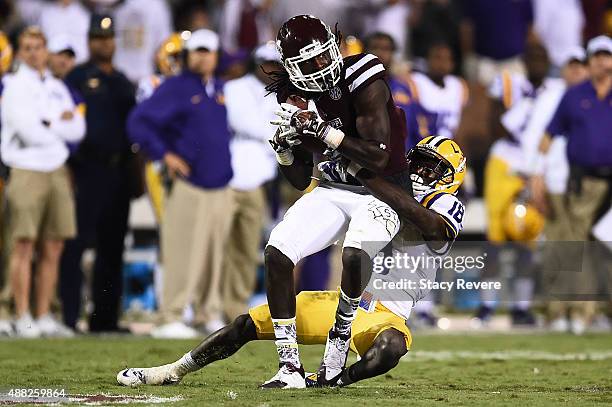 De'Runnya Wilson of the Mississippi State Bulldogs is brought down by Tre'Davious White of the LSU Tigers during a game at Davis Wade Stadium on...