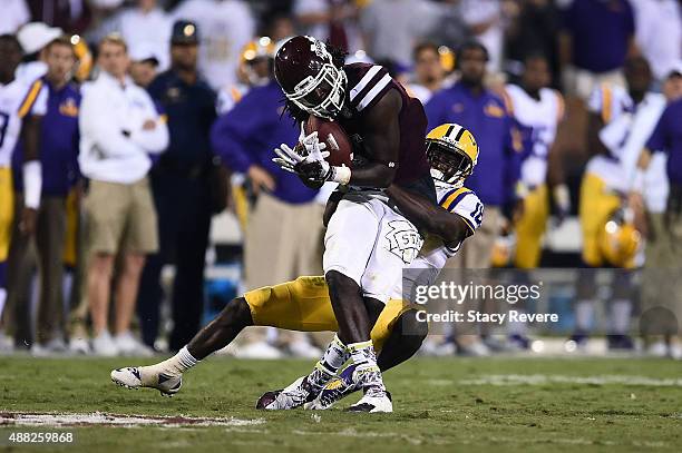 De'Runnya Wilson of the Mississippi State Bulldogs is brought down by Tre'Davious White of the LSU Tigers during a game at Davis Wade Stadium on...