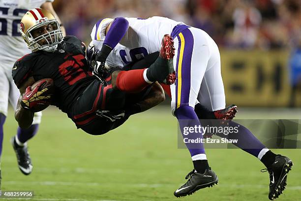 Vernon Davis of the San Francisco 49ers is tackled by Robert Blanton of the Minnesota Vikings after a catch during their NFL game at Levi's Stadium...