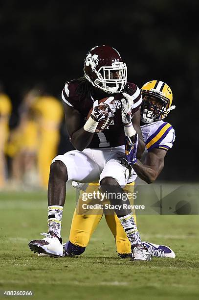 De'Runnya Wilson of the Mississippi State Bulldogs is brought down by Dwayne Thomas of the LSU Tigers during a game at Davis Wade Stadium on...