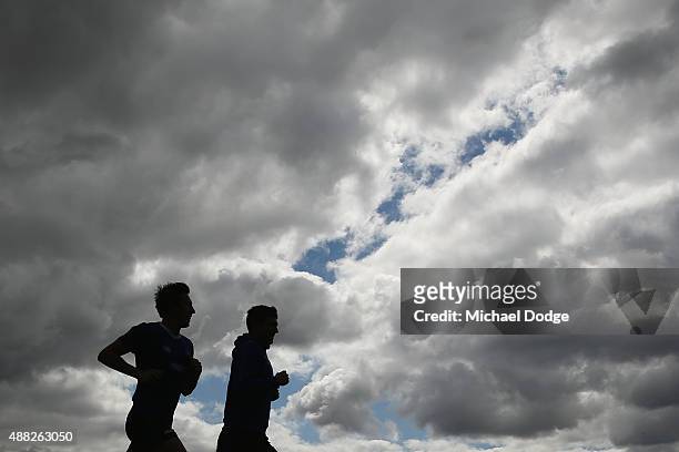 Jarrad Waite and Shaun Atley run a lap during a North Melbourne Kangaroos AFL media session at Arden Street Ground on September 15, 2015 in...