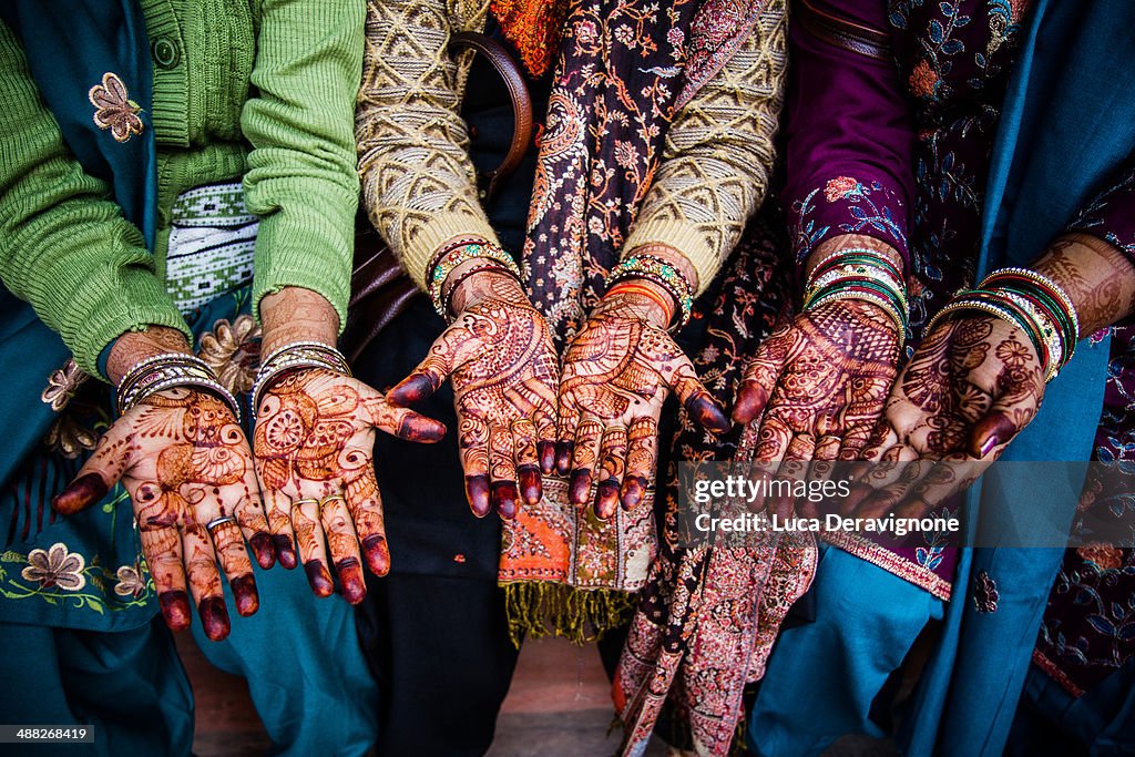 Women's hands painted with henna