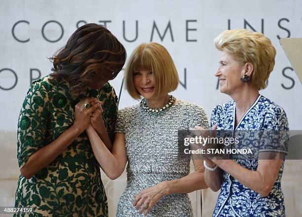 First Lady Michelle Obama , Vogue Magazine Editor Anna Wintour and Emily K. Rafferty , President of the Metropolitan Museum after Obama cut the...