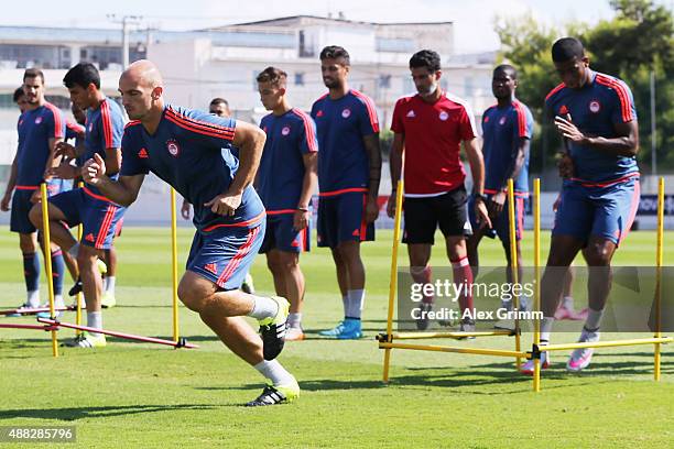Esteban Cambiasso and team mates exercise during a Olympiacos FC training session ahead of their UEFA Champions League Group F match against Bayern...